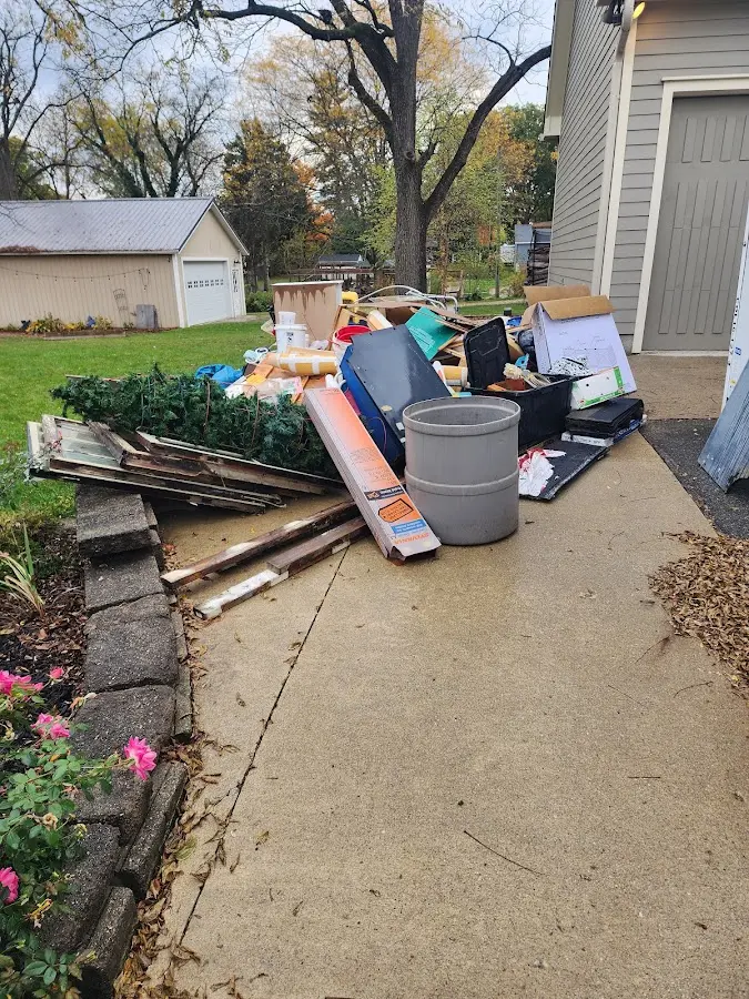 Dumpster being loaded with debris for Estate Cleanout Dumpster Rental in Gonzalez